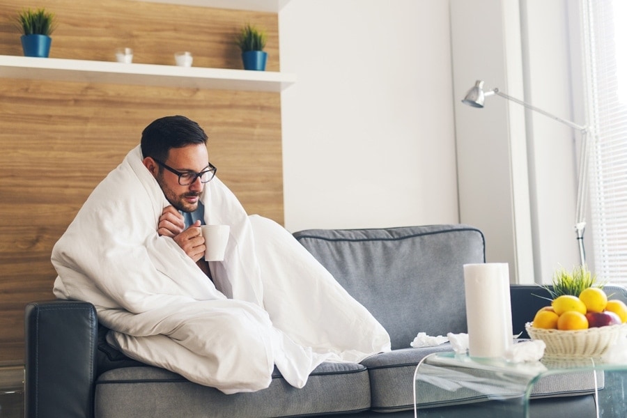 Man staying warm on the couch. Why is my furnace blowing cold air?