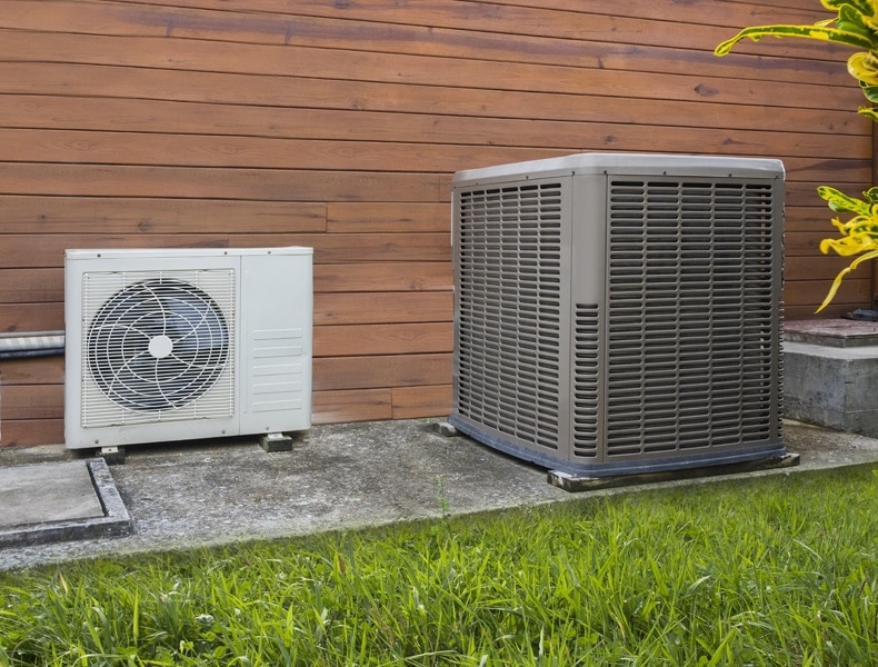 Air conditioning heat pumps on the side of a house. What is a heat pump?