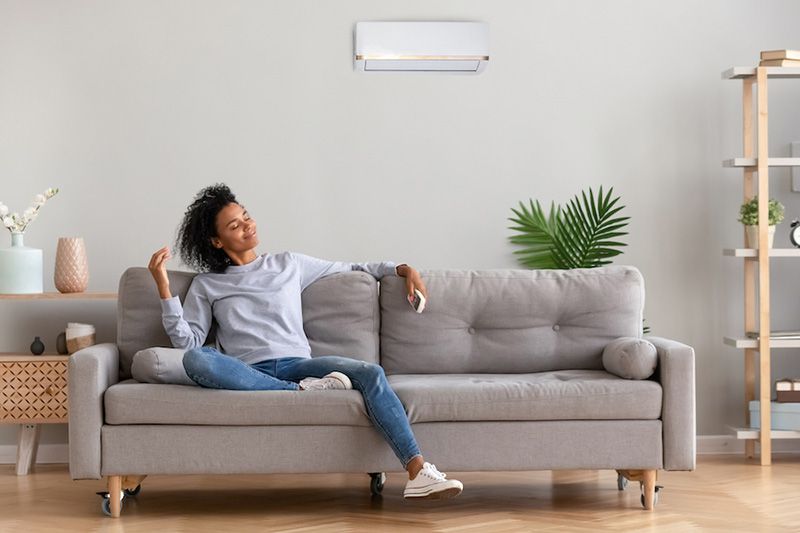 What Accessories Can Help With My Indoor Air Quality? Image shows woman sitting on a couch.